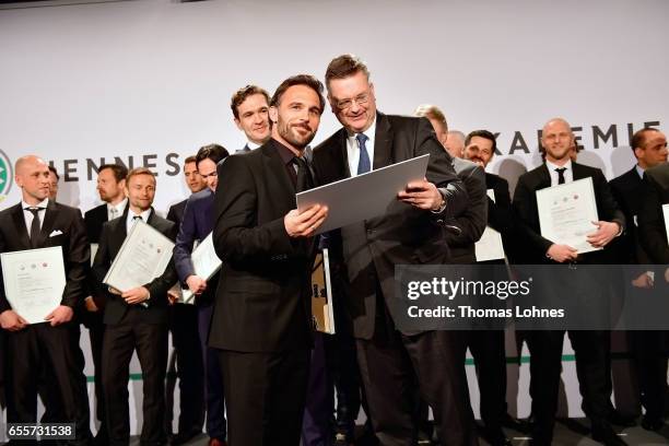 Damir Dugandzic gets his certificate as new football coach from DFB president Reinhard Grindel during the 'Coaching Award Ceremony & Closing Event...