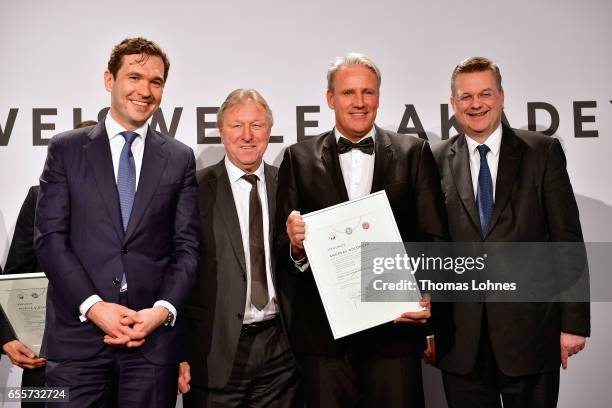 The new DFB fototball coach Andreas Golombek stands with his certificate between DFB general secretary Friedrich Curtius, Horst Hrubesch and DFB...