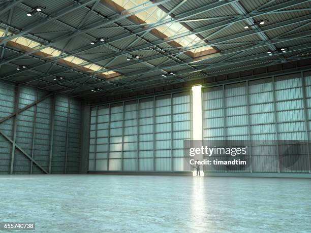 woman in an empty warehouse by day - empty warehouse stock pictures, royalty-free photos & images