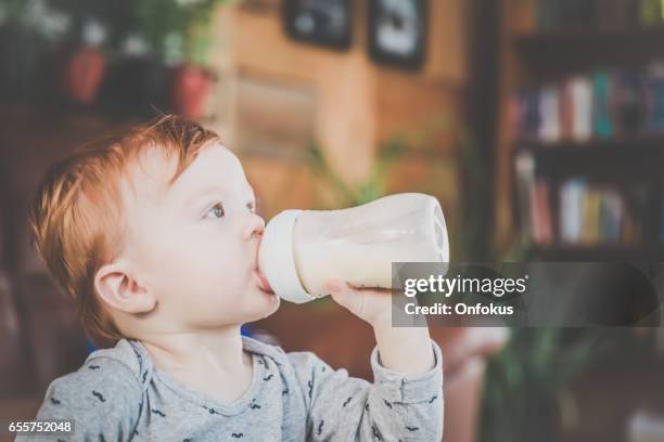 baby boy with milk bottle - milk bottles stock pictures, royalty-free photos & images