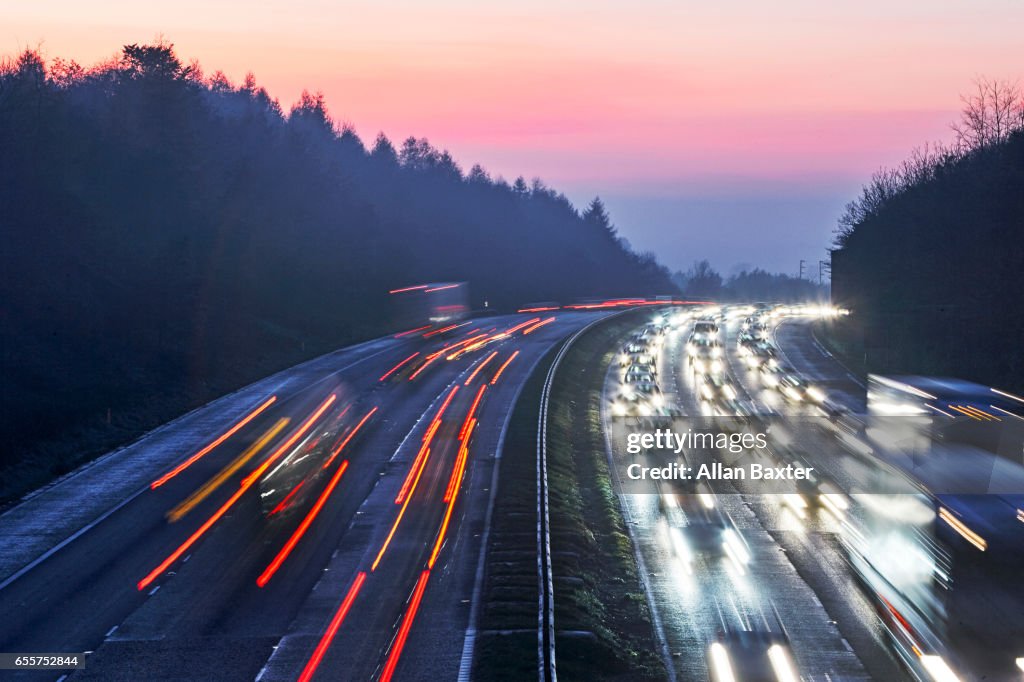Car lights along the M4 motorway lit at dusk