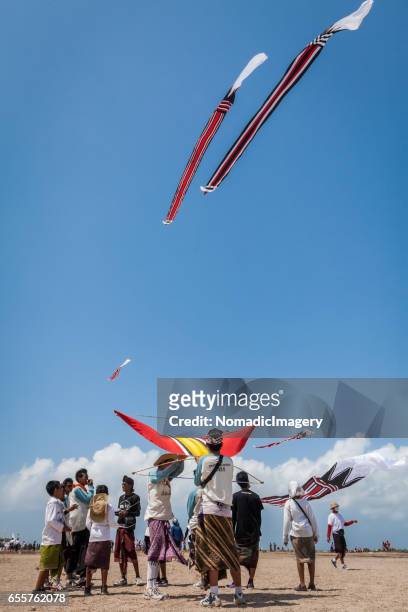 young kite flyers at a bali kite flying festival - indonesian kite stock pictures, royalty-free photos & images
