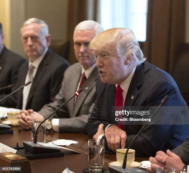 President Donald Trump, center, speaks during a meeting with Haider al-Abadi, Iraq's prime minister, not pictured, at the White House in Washington,...