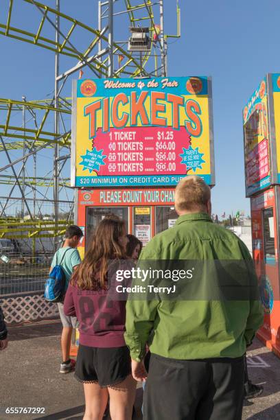 family and friends wait in line to buy tickets for the collier county fair - amusement park ticket stock pictures, royalty-free photos & images