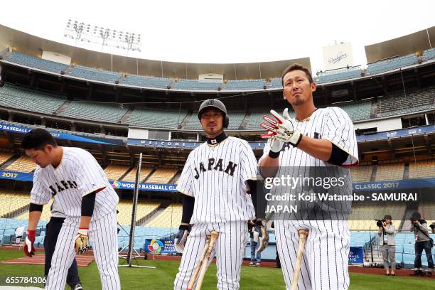 Sho Nakata and Ryosuke Kikuchi of Japan look on during a training session ahead of the World Baseball Classic Championship Round at Dodger Stadium on...