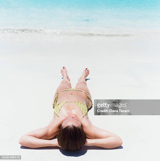 woman sunbathing on beach - hot puerto rican women stock-fotos und bilder