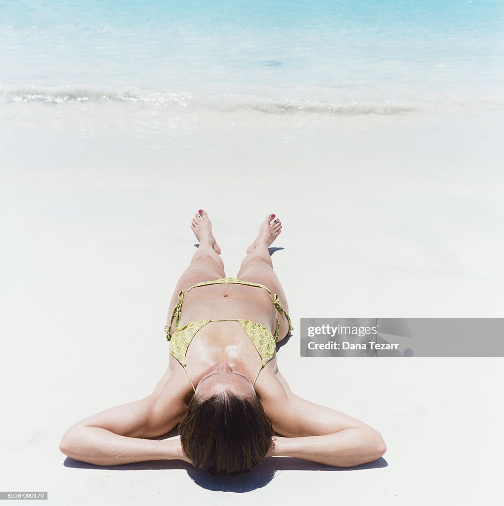 Woman Sunbathing on Beach