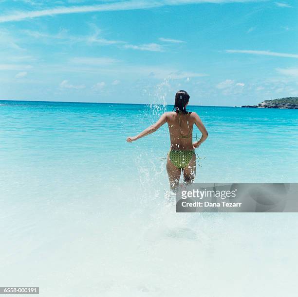 woman splashing in ocean - hot puerto rican women stock-fotos und bilder