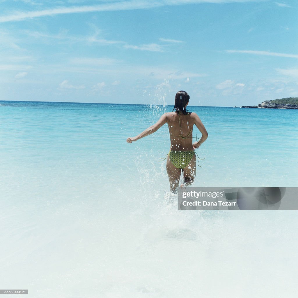 Woman Splashing in Ocean