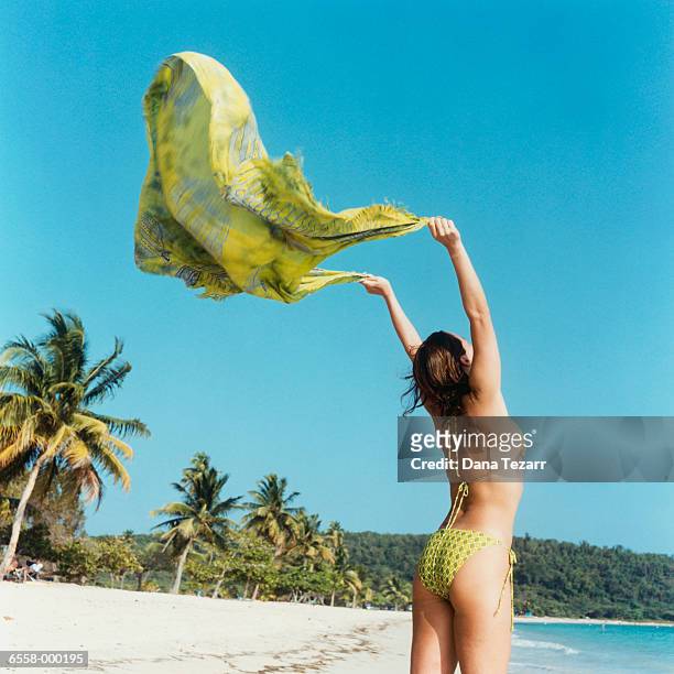 woman holding sarong on beach - hot puerto rican women stock-fotos und bilder