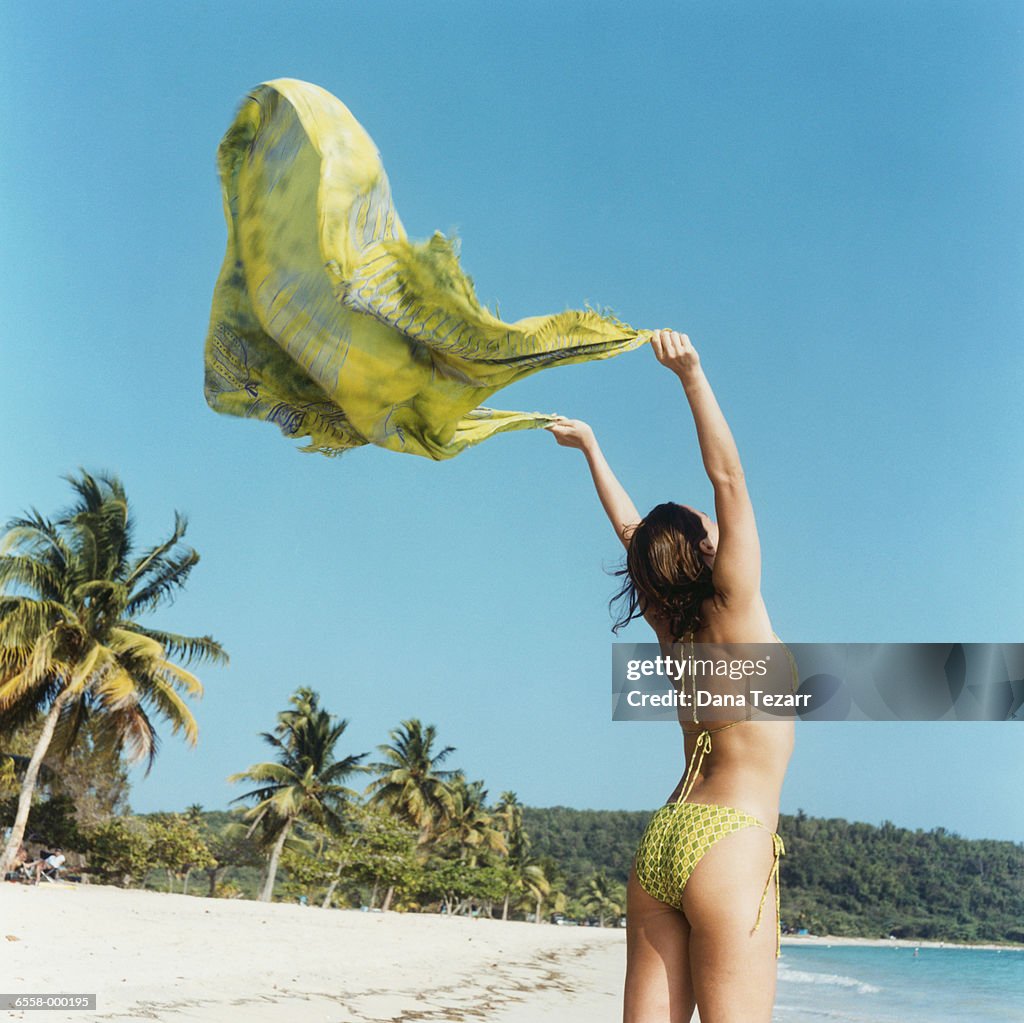 Woman Holding Sarong on Beach