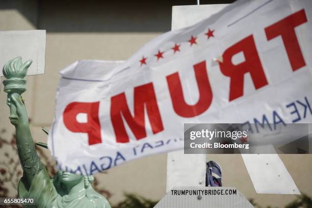 Trump flag flies in front of a model of the Statue of Liberty before the start of a rally for U.S. President Donald Trump outside of the Kentucky...