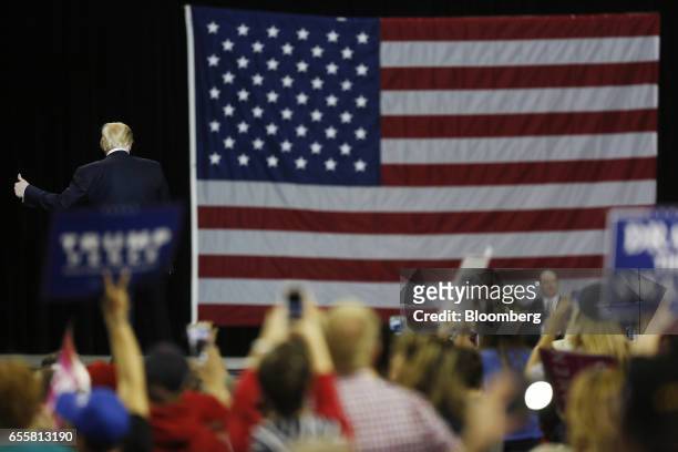 President Donald Trump gives a thumbs up to attendees as he arrives for a rally at the Kentucky Exposition Center in Louisville, Kentucky, U.S., on...