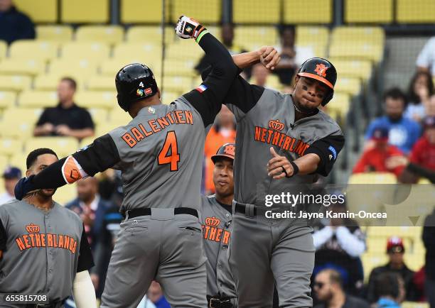 Wladimir Balentien and Xander Bogaerts of the Netherlands celebrate Balentien's 2-run home run against team Puerto Rico in the first inning during...
