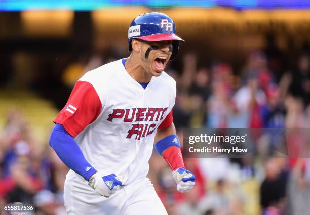 Carlos Correa of the Puerto Rico celebrates his two-run home run to tie the game 2-2 in the first inning against team Netherlands during Game 1 of...