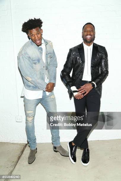 Chicago Bulls teammates Jimmy Butler and Dwyane Wade share a laugh while striking a pose backstage at Dwyane Wade's A Night on the Runwade Fashion...