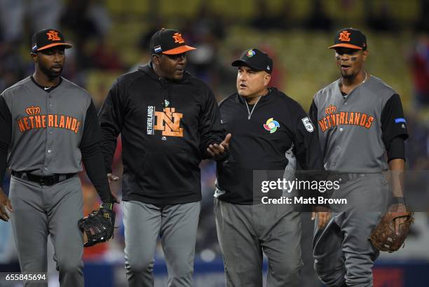 Manager Hensely Muelens of Team Netherlands comes out to talk to third base umpire Eric Cooper in the fourth inning of Game 1 of the Championship...