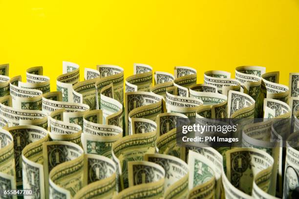 sea of us 1 dollar bills on yellow background - american one dollar bill stock pictures, royalty-free photos & images