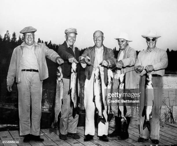 The five Eisenhower brothers, enjoying their first vacation together since 1920, exhibit the results of one day's fishing at Minocqua, Wisconsin....