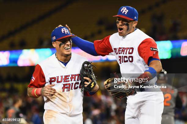 Carlos Correa and T.J. Rivera of the Puerto Rico after a double play to end the ninth inning against team Netherlands during Game 1 of the...