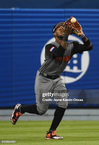 Jurickson Profar of the Netherlands catches a fly out by Enrique Hernandez of the Puerto Rico to end the tenth inning during Game 1 of the...