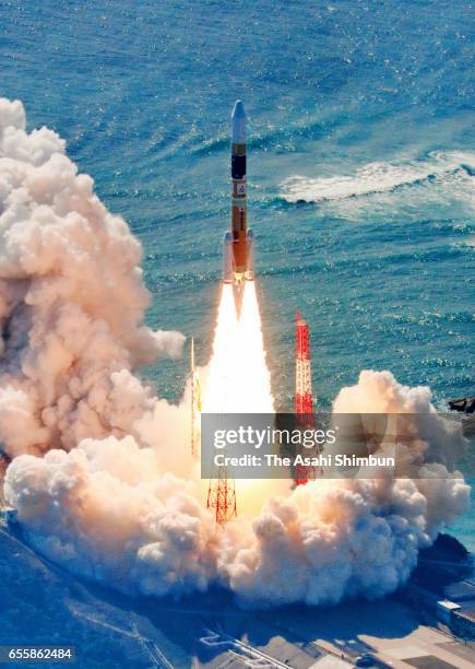 In this aerial image, the H2A-33 rocket carrying an intelligent gathering satellite lifts off from the Japan Aerospace Exploration Agency's...