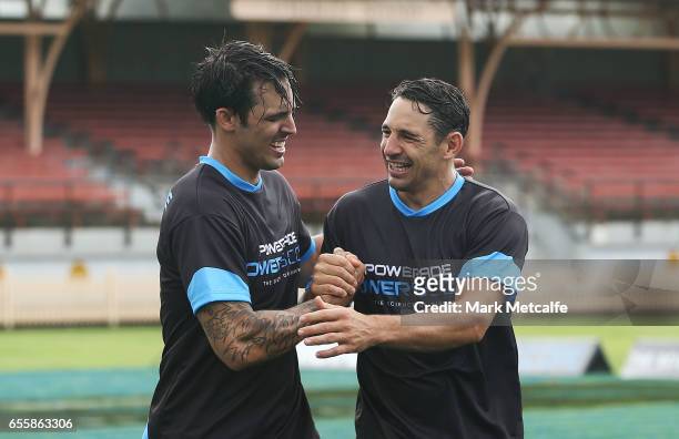 Mitchell Johnson and Billy Slater shake hands after taking part in the endurance test during the Powerade Powerscore Launch Event at North Sydney...