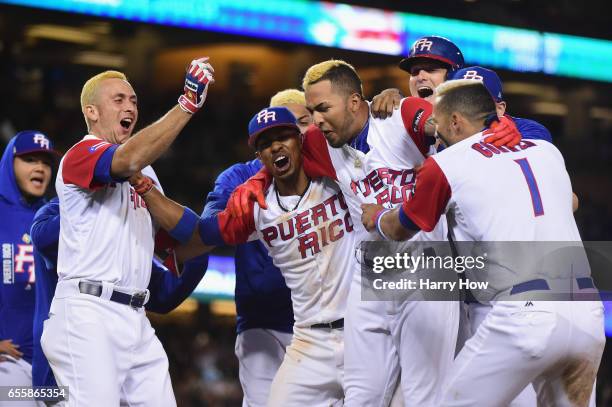 Eddie Rosario of the Puerto Rico celebrates with teammates after getting the game-winning hit in the 11th inning for a 4-3 win over team Netherlands...