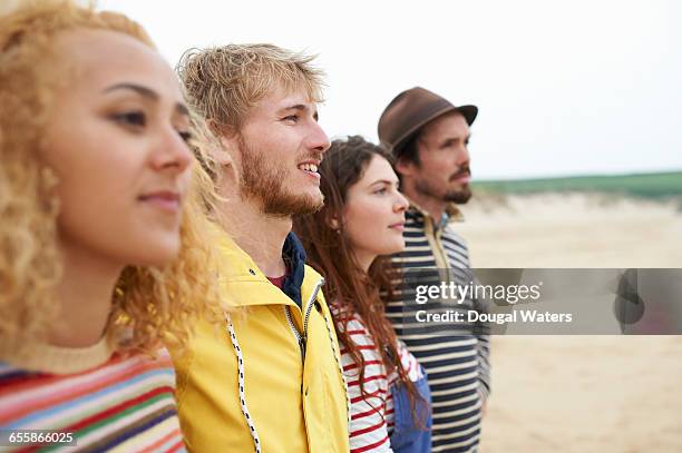 two couples standing together on beach. - people in a line stock pictures, royalty-free photos & images
