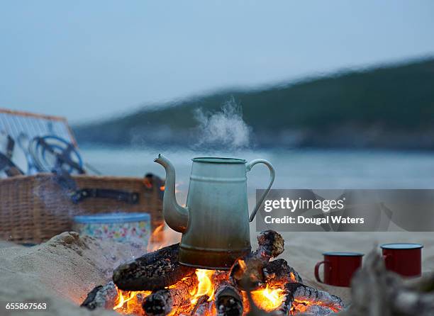 kettle boiling on campfire at beach. - boiling water stock pictures, royalty-free photos & images