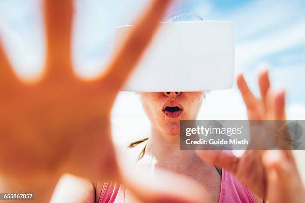 woman using a virtual reality headset. - longeville sur mer stock pictures, royalty-free photos & images