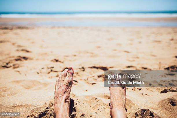 woman and man feet on the beach. - longeville sur mer stock pictures, royalty-free photos & images