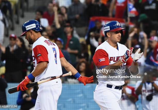 Rivera of the Puerto Rico walks off after celebrating his home run with teammate Reymond Fuentes in the second inning against team Netherlands during...