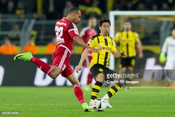 Marcel Tisserand of Ingolstadt and Shinji Kagawa of Dortmund battle for the ball during the Bundesliga match between Borussia Dortmund and FC...