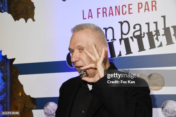 Jean Paul Gaultier poses with a coin he designed during "France By Jean Paul Gaultier": Limited Coin Collection Press Preview At La Monnaie de Paris...