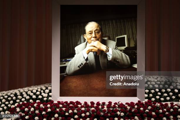 Flowers are seen surrounding a portrait of the businessman Masaya Nakamura, the founder of video game company Bandai Namco and known as the "father"...