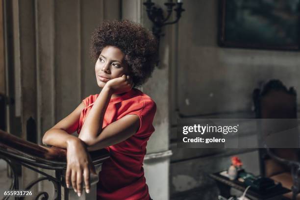 pensive beautiful young cuban woman  in old house in havanna - leaning on elbows stock pictures, royalty-free photos & images