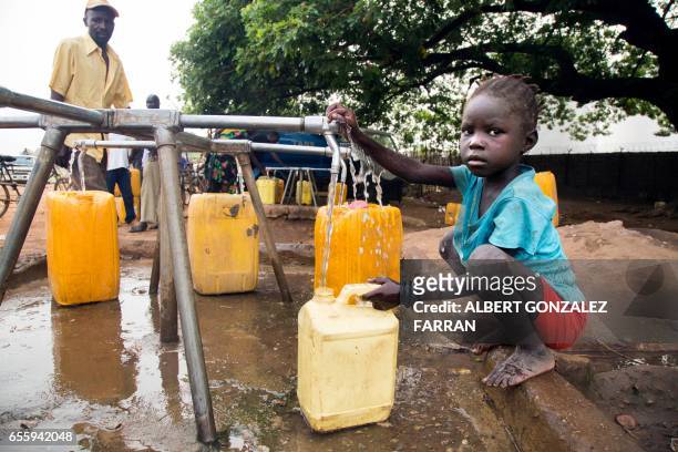 Child collects water from a water point in Juba, South Sudan, on March 21, 2017. - International World Water Day is marked annually on March 22 to...