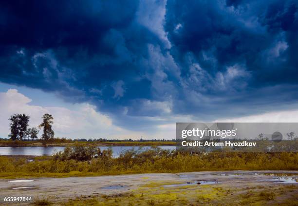 heavy storm clouds, against the backdrop of a village road, day, outdoor - heavy storm in kiev stock pictures, royalty-free photos & images