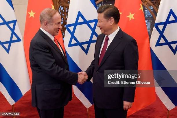 Chinese President Xi Jinping and Israeli Prime Minister Benjamin Netanyahu shake hands ahead of their talks at Diaoyutai State Guesthouse on March...