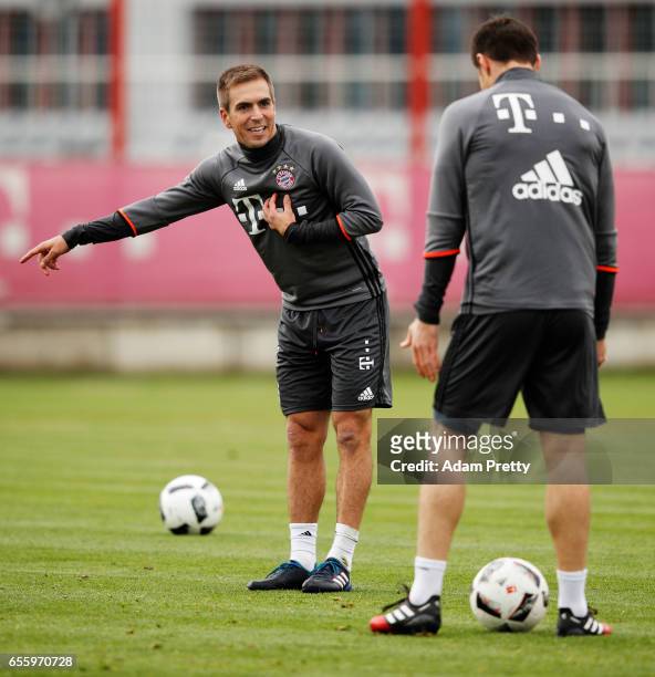 Philipp Lahm of Bayern Muenchen interacts with Xabi Alonso during FC Bayern Muenchen training at Saebener Strasse training ground on March 21, 2017...