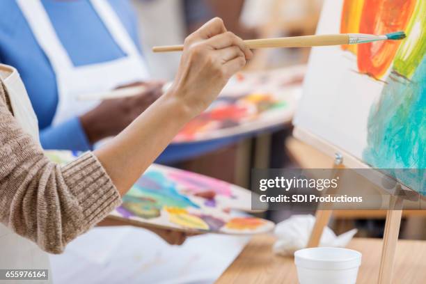 close up of female artist's hand - hands painting stock pictures, royalty-free photos & images