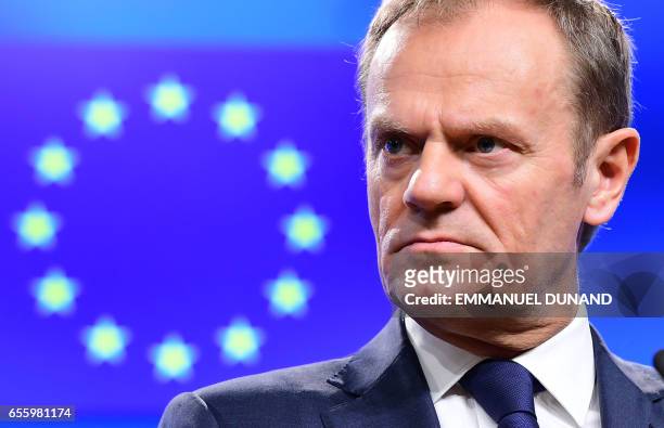 European Council President Donald Tusk reacts during a press statement announcing that an EU leaders' summit will take place to decide the political...
