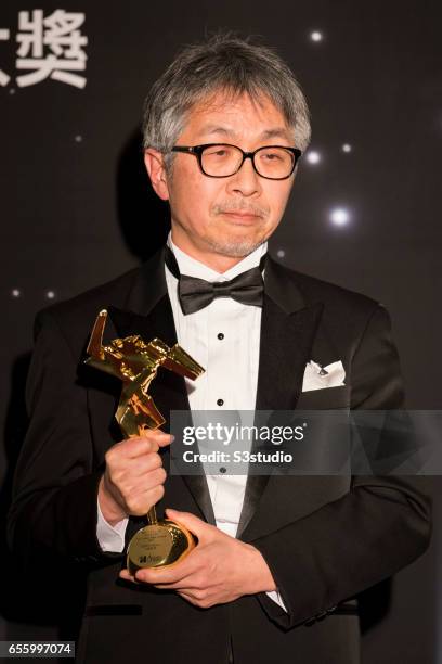 Tetsuo Ohya, winner of the Best Visual Effects award for 'Shin Godzilla', poses with the award during the 11th Asian Film Awards on March 21, 2017 at...