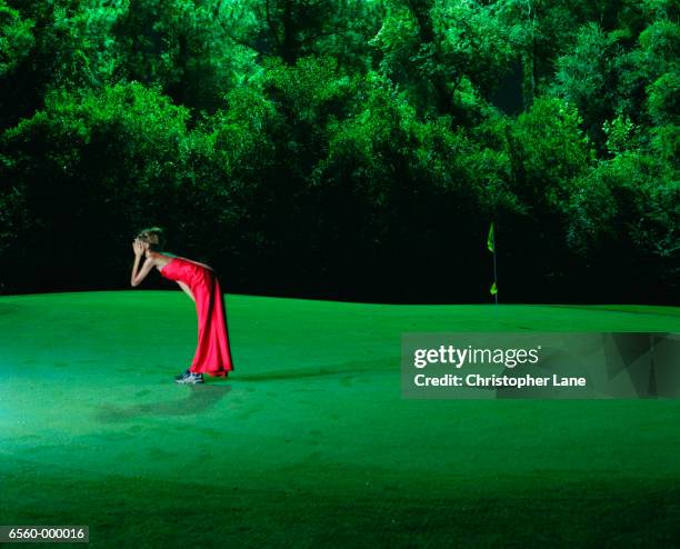 woman in red on golf green - tomato_response stock pictures, royalty-free photos & images