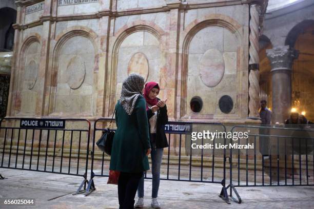 People visit The tomb of Jesus Christ with the rotunda is seen in the Church of the Holy Sepulchre on March 21, 2017 in Jerusalem, Israel. The tomb...