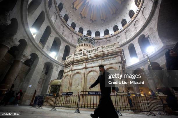 Prist walks outside The tomb of Jesus Christ in the Church of the Holy Sepulchre on March 21, 2017 in Jerusalem, Israel. The tomb of Jesus Christ in...