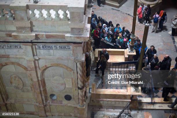 People visit The tomb of Jesus Christ with the rotunda is seen in the Church of the Holy Sepulchre on March 21, 2017 in Jerusalem, Israel. The tomb...