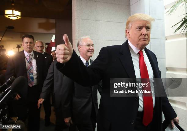 President Donald Trump gives a thumbs up as he and HHS Secretary Tom Price walk to a House Republican closed party conference on Capitol Hill, on...