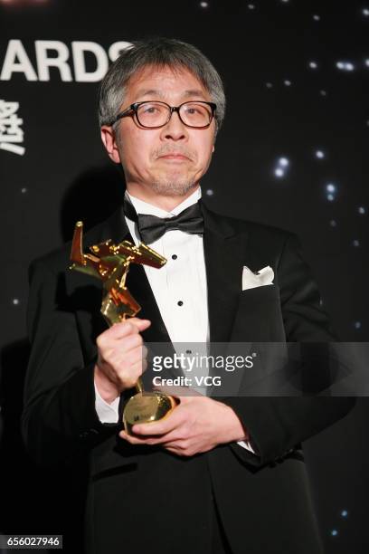Tetsuo Ohya, winner of the Best Visual Effects award for 'Shin Godzilla', celebrates at the backstage during the 11th Asian Film Awards at Hong Kong...